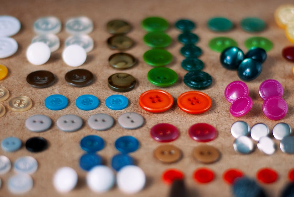 Various colorful buttons arranged neatly on a textured surface.